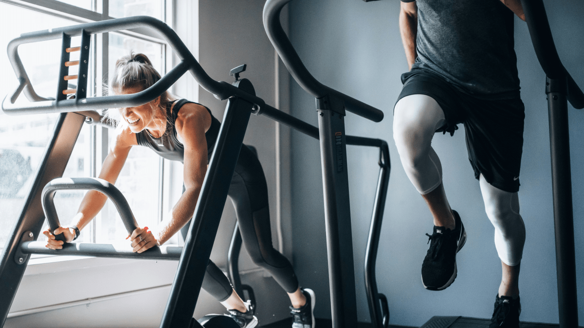 A man and a woman working out on treadmills | Ultimate Nutrition