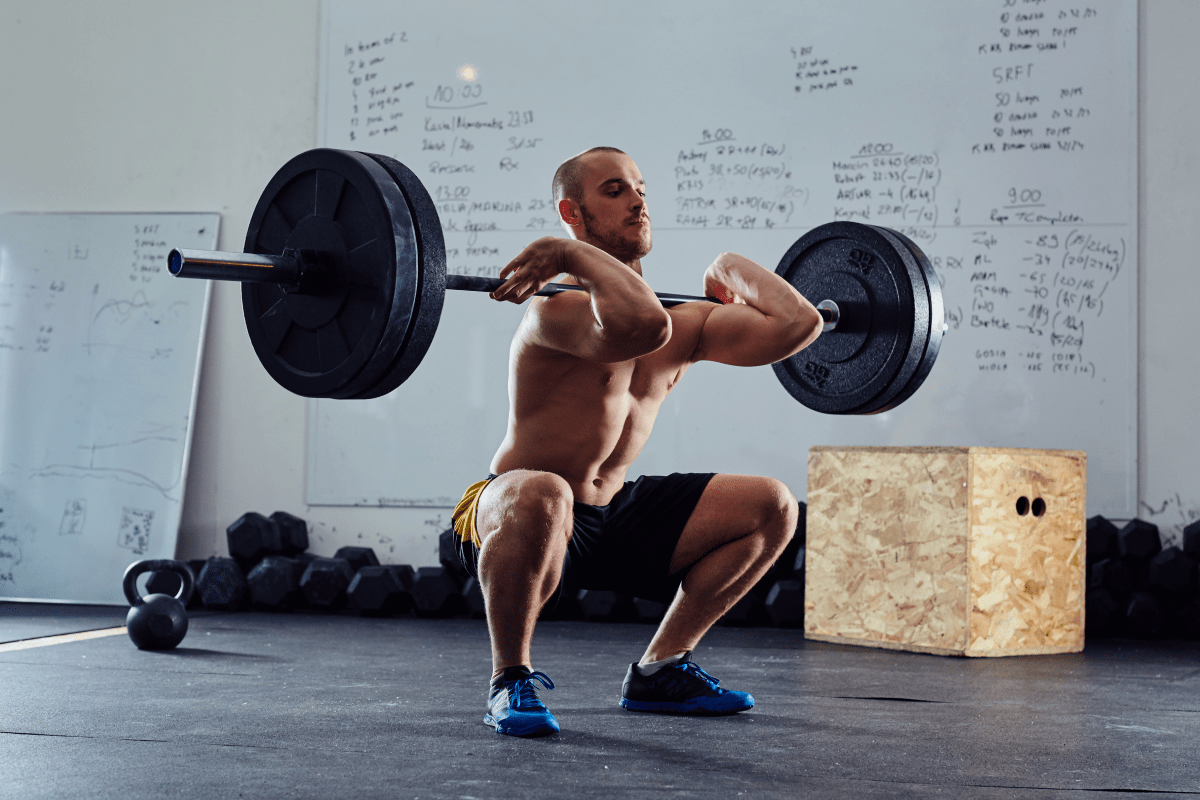 A man front squatting | Ultimate Nutrition