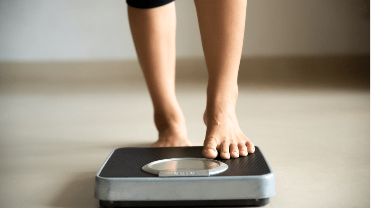 Standing on a scale | Ultimate Nutrition