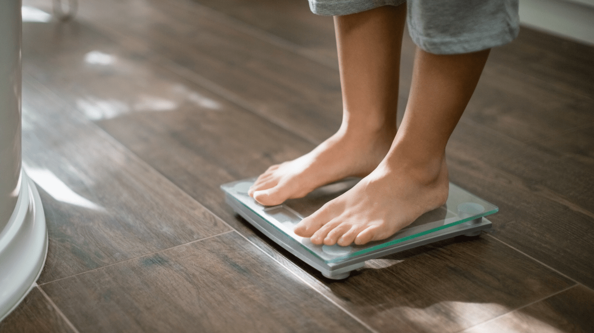 Standing on a scale | Ultimate Nutrition