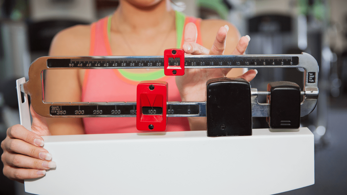 A woman on a scale | Ultimate Nutrition