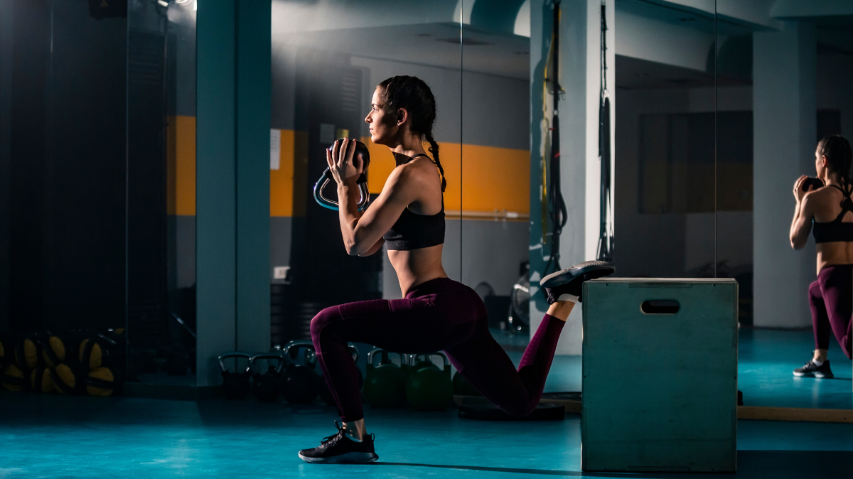 A woman performing a Bulgarian Split Squat | Ultimate Nutrition