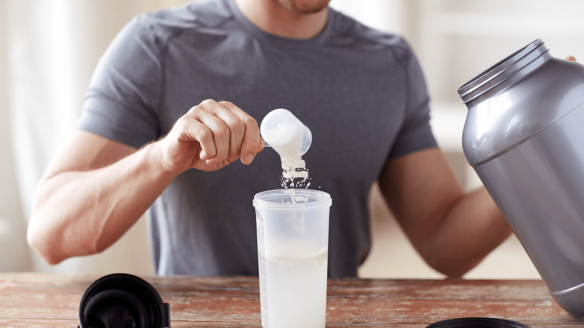a man making a protein shake | Ultimate Nutrition