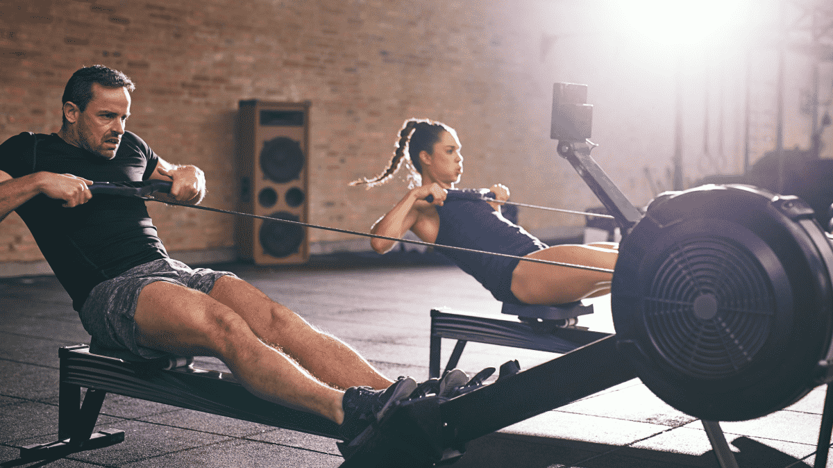 A man and a woman performing a rowing workout | Ultimate Nutrition
