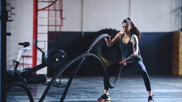 Woman using battle ropes
