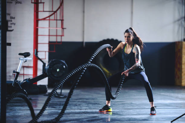 Woman using battle ropes