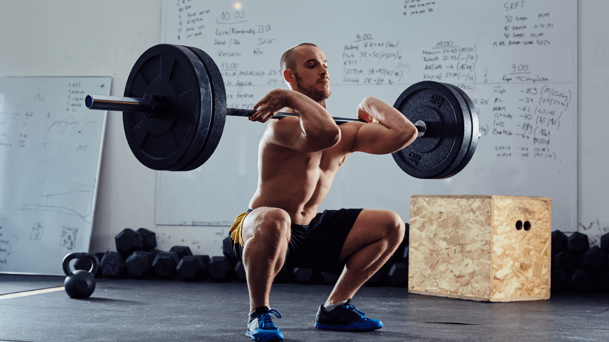 A man front squatting | Ultimate Nutrition