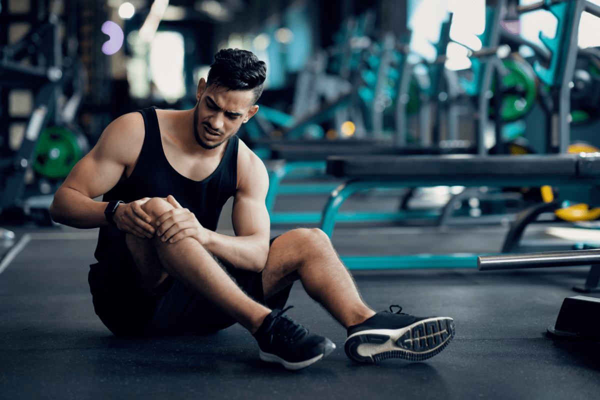 A man with knee strain | Ultimate Nutrition