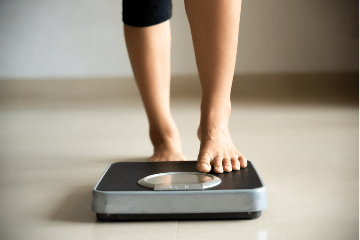 Standing on a scale | Ultimate Nutrition