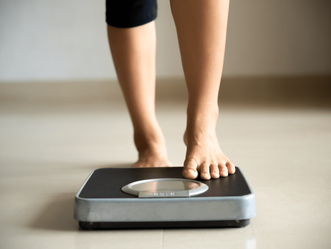 Standing on a scale | Ultimate Nutrition