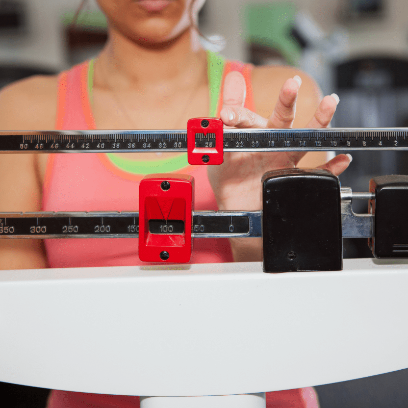 A woman on a scale | Ultimate Nutrition