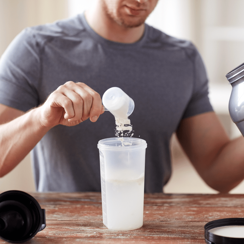 a man making a protein shake | Ultimate Nutrition