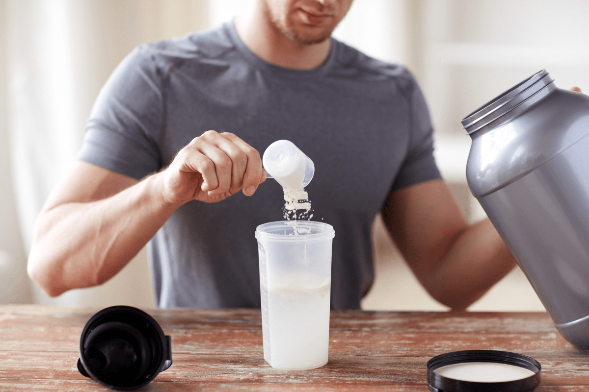 a man making a protein shake | Ultimate Nutrition