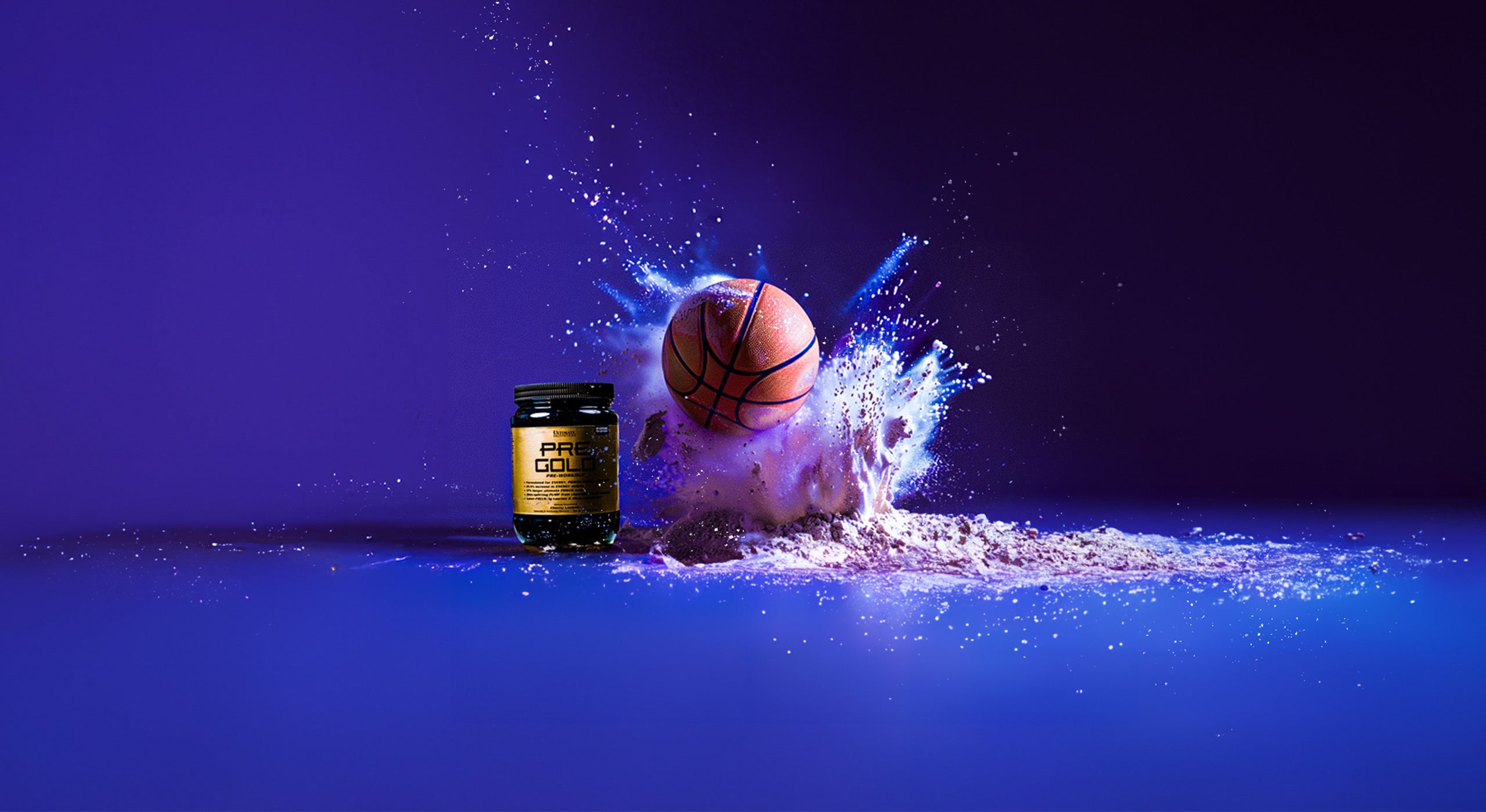 A 'PRE GOLD' supplement jar and a basketball with a dynamic white protein powder splash against a purple background, suggesting energy and performance